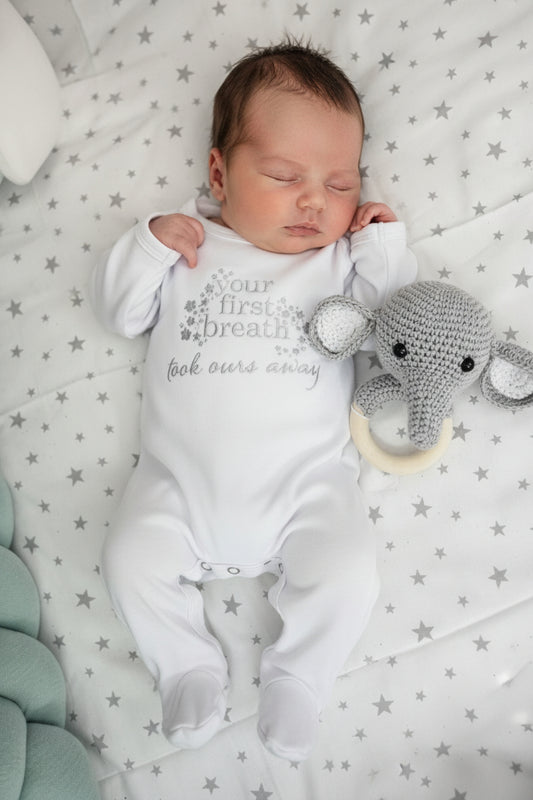 White baby romper with text