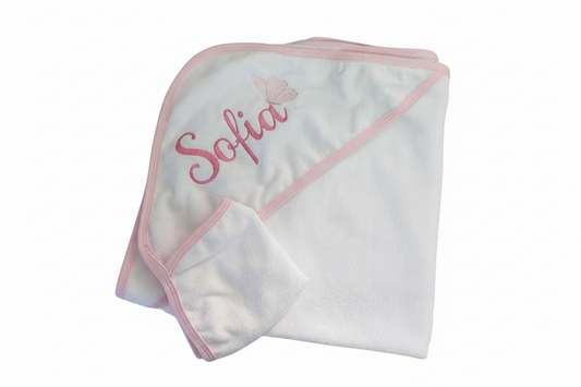White hooded towel with pink trim and personalised embroidered name on a white background